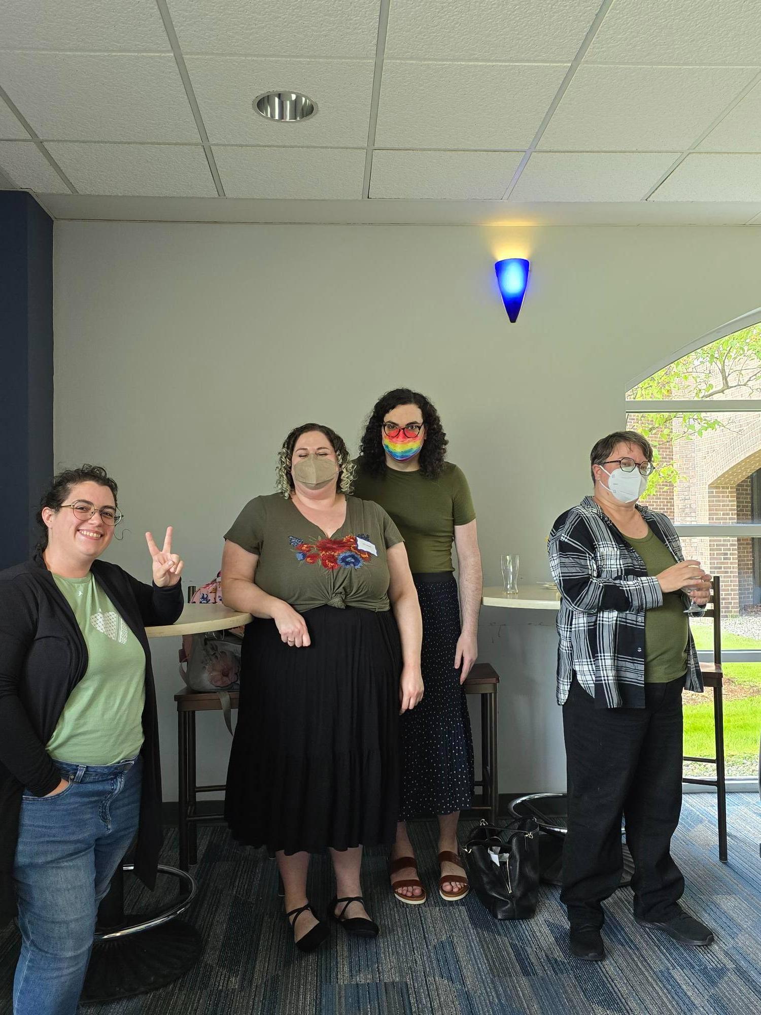 four SIS faculty stand in the Thornapple Room